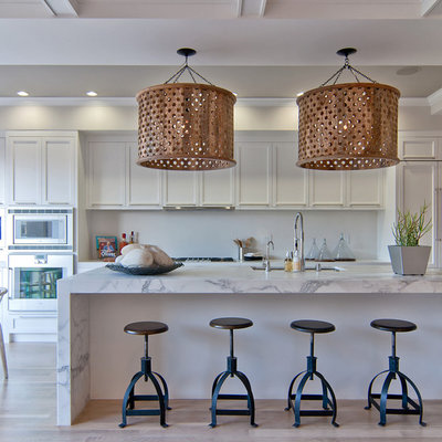 Inspiration for a transitional galley eat-in kitchen remodel in San Francisco with an undermount sink, recessed-panel cabinets, white cabinets and paneled appliances