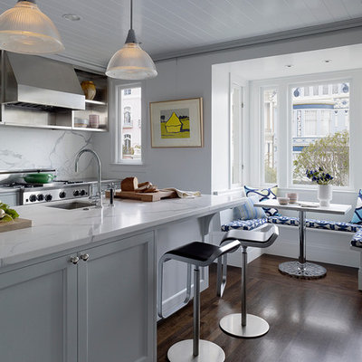 Large transitional galley dark wood floor eat-in kitchen photo in San Francisco with white backsplash, a double-bowl sink, shaker cabinets, white cabinets, marble countertops, stainless steel appliances, an island and marble backsplash