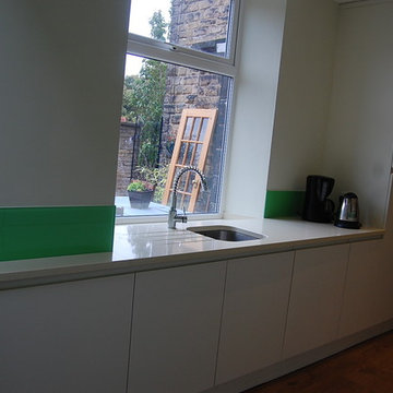 Painted bespoke kitchen with glass splashback and upstand