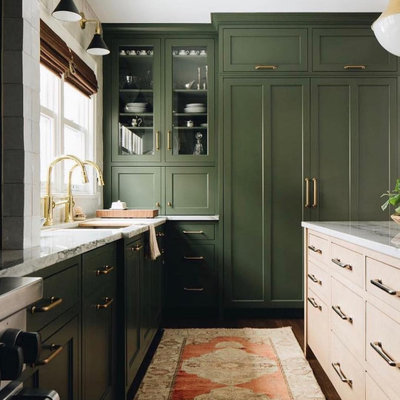 Large transitional l-shaped medium tone wood floor and brown floor kitchen photo in Columbus with an undermount sink, recessed-panel cabinets, green cabinets, marble countertops, white backsplash, ceramic backsplash, stainless steel appliances, an island and white countertops