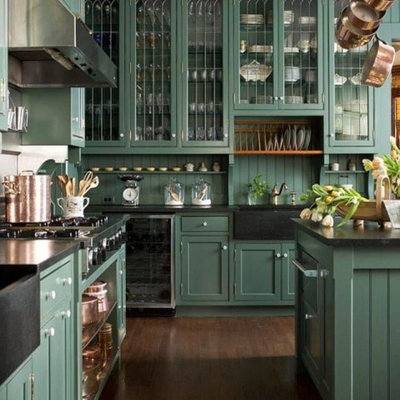 Eat-in kitchen - large traditional l-shaped dark wood floor and brown floor eat-in kitchen idea in Columbus with a farmhouse sink, recessed-panel cabinets, green cabinets, soapstone countertops, green backsplash, stainless steel appliances, an island and black countertops