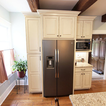 Painted Cream with Brown Glaze Cabinets with Giallo Granite Countertops ~ Sevill