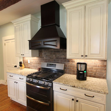 Painted Cream with Brown Glaze Cabinets with Giallo Granite Countertops ~ Sevill