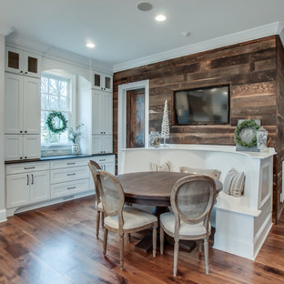 Inspiration for a large shabby-chic style u-shaped eat-in kitchen in Wichita with a farmhouse sink, recessed-panel cabinets, white cabinets, marble benchtops, beige splashback, subway tile splashback, stainless steel appliances, medium hardwood floors and with island.