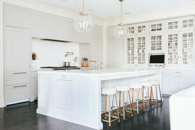Large transitional l-shaped dark wood floor eat-in kitchen photo in Chicago with a farmhouse sink, shaker cabinets, white cabinets, marble countertops, white backsplash, glass tile backsplash, stainless steel appliances and an island