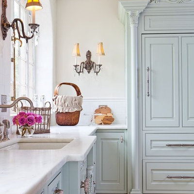 Inspiration for a mid-sized shabby-chic style u-shaped ceramic tile enclosed kitchen remodel in St Louis with an undermount sink, raised-panel cabinets, green cabinets, white backsplash, subway tile backsplash, paneled appliances and wood countertops