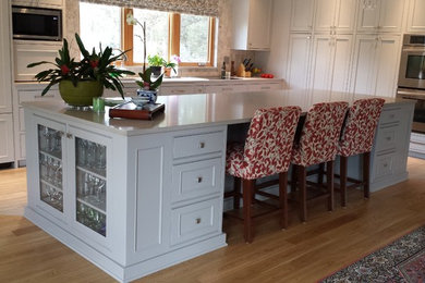 Arts and crafts l-shaped medium tone wood floor eat-in kitchen photo in Other with an undermount sink, beaded inset cabinets, gray cabinets, quartzite countertops, gray backsplash, stainless steel appliances and an island