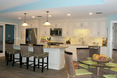 Example of a large minimalist galley porcelain tile eat-in kitchen design in Tampa with raised-panel cabinets, light wood cabinets, granite countertops, multicolored backsplash, stone slab backsplash, stainless steel appliances and an island