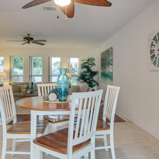 Photo of a small tropical galley separate kitchen with flat-panel cabinets, medium wood cabinets, laminate benchtops, green splashback, no island, a double-bowl sink, white appliances, ceramic floors and white floor.