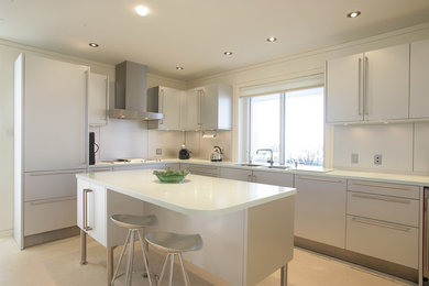 Photo of a medium sized modern l-shaped open plan kitchen in Other with flat-panel cabinets, white cabinets, composite countertops, grey splashback, stainless steel appliances, porcelain flooring, an island, beige floors and white worktops.