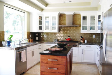 Example of a small transitional u-shaped porcelain tile eat-in kitchen design in Los Angeles with an undermount sink, shaker cabinets, white cabinets, granite countertops, beige backsplash, subway tile backsplash, stainless steel appliances and an island