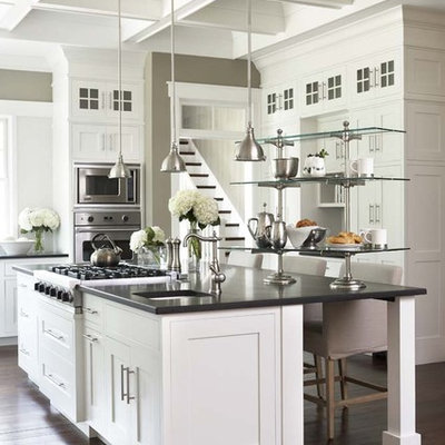 Open concept kitchen - large traditional u-shaped dark wood floor open concept kitchen idea in Charleston with stainless steel appliances, shaker cabinets, an island, granite countertops, an undermount sink and black countertops