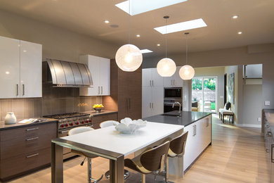 Large trendy galley light wood floor and beige floor enclosed kitchen photo in San Francisco with flat-panel cabinets, quartz countertops, gray backsplash, an island, stainless steel appliances, an integrated sink, medium tone wood cabinets and porcelain backsplash