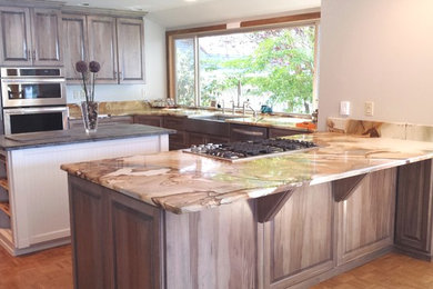 Inspiration for a large timeless u-shaped medium tone wood floor open concept kitchen remodel in Seattle with an undermount sink, raised-panel cabinets, medium tone wood cabinets, granite countertops, multicolored backsplash, stone slab backsplash, stainless steel appliances and a peninsula