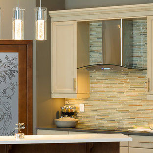 Design ideas for a mid-sized asian l-shaped kitchen pantry in Other with raised-panel cabinets, medium wood cabinets, granite benchtops, beige splashback, ceramic splashback, stainless steel appliances and with island.