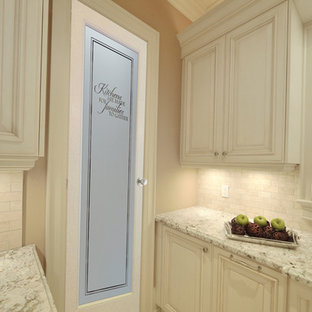 Inspiration for a mid-sized l-shaped kitchen pantry remodel in Other with raised-panel cabinets, medium tone wood cabinets, granite countertops, beige backsplash, ceramic backsplash, stainless steel appliances and an island