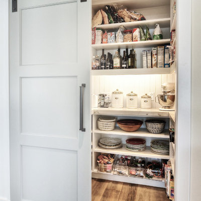Inspiration for a large transitional medium tone wood floor kitchen pantry remodel in Orange County with an undermount sink, white cabinets, granite countertops, stainless steel appliances, subway tile backsplash and open cabinets