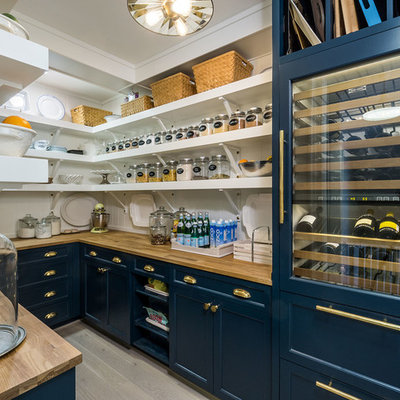 Inspiration for a cottage u-shaped light wood floor and beige floor kitchen pantry remodel in Portland with open cabinets, blue cabinets, wood countertops, white backsplash, no island and paneled appliances