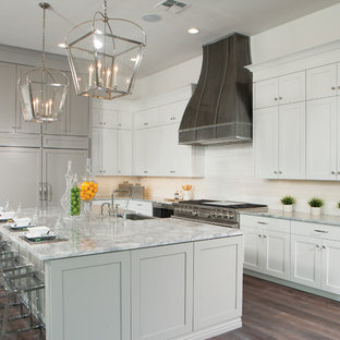 Large transitional open concept kitchen photos - Open concept kitchen - large transitional l-shaped dark wood floor and brown floor open concept kitchen idea in Phoenix with a farmhouse sink, shaker cabinets, white cabinets, white backsplash, paneled appliances, an island, marble countertops and marble backsplash