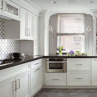 This is an example of a small traditional u-shaped kitchen in New York with an undermount sink, recessed-panel cabinets, white cabinets, onyx benchtops, white splashback, mosaic tile splashback, stainless steel appliances, ceramic floors and no island.