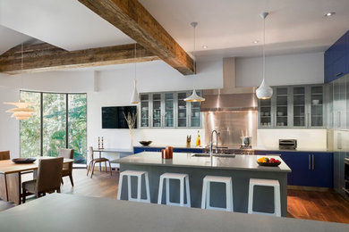 Eat-in kitchen - large contemporary u-shaped dark wood floor eat-in kitchen idea in Denver with an undermount sink, flat-panel cabinets, blue cabinets, quartz countertops, white backsplash and stainless steel appliances