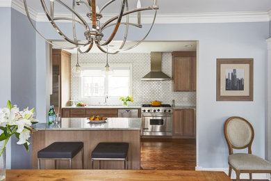 Eat-in kitchen - mid-sized transitional l-shaped medium tone wood floor and brown floor eat-in kitchen idea in Chicago with an undermount sink, recessed-panel cabinets, light wood cabinets, quartzite countertops, white backsplash, ceramic backsplash, stainless steel appliances, an island and gray countertops