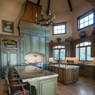 Inspiration for an expansive country galley open plan kitchen in Salt Lake City with a farmhouse sink, recessed-panel cabinets, green cabinets, granite benchtops, white splashback, mosaic tile splashback, panelled appliances, ceramic floors and multiple islands.