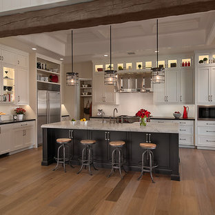 Kitchen - traditional kitchen idea in Phoenix with stainless steel appliances, white cabinets, recessed-panel cabinets and white backsplash