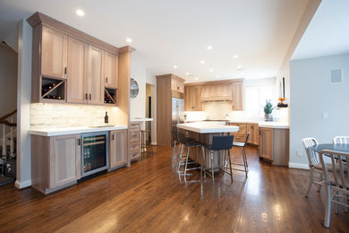 Example of a classic eat-in kitchen design in Chicago with shaker cabinets, gray cabinets, stainless steel appliances and an island