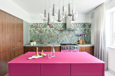 Eat-in kitchen - large contemporary l-shaped concrete floor eat-in kitchen idea in New York with a double-bowl sink, flat-panel cabinets, medium tone wood cabinets, concrete countertops, multicolored backsplash, glass tile backsplash, colored appliances and an island