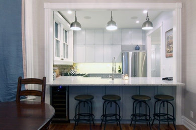Eat-in kitchen - mid-sized transitional u-shaped dark wood floor eat-in kitchen idea in New York with a farmhouse sink, shaker cabinets, white cabinets, granite countertops, beige backsplash, stainless steel appliances and no island