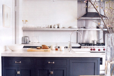 Example of a trendy u-shaped eat-in kitchen design in New York with an undermount sink, shaker cabinets, black cabinets, concrete countertops, gray backsplash, cement tile backsplash and stainless steel appliances