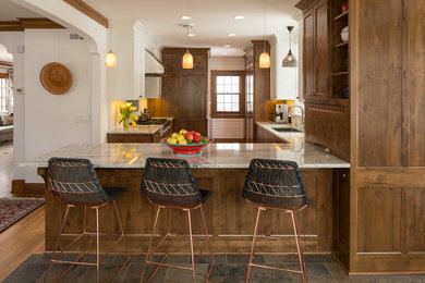 Kitchen - small traditional u-shaped medium tone wood floor and brown floor kitchen idea in Minneapolis with a double-bowl sink, shaker cabinets, medium tone wood cabinets, granite countertops, white backsplash, porcelain backsplash, stainless steel appliances and a peninsula