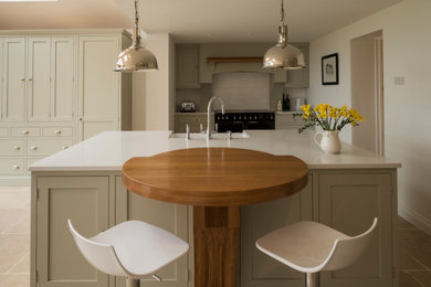 This is an example of a kitchen in Gloucestershire with shaker cabinets and an island.