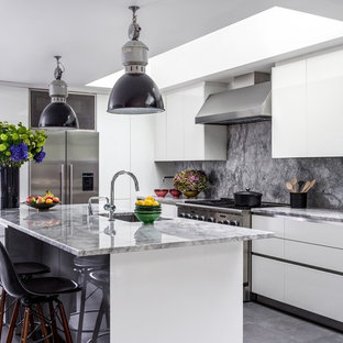 Design ideas for a large contemporary l-shaped kitchen in London with a submerged sink, flat-panel cabinets, white cabinets, grey splashback, stainless steel appliances, an island, grey floors, grey worktops and marble worktops.