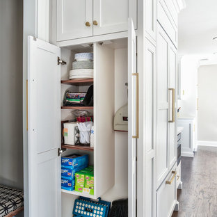 Transitional kitchen ideas - Kitchen - transitional dark wood floor kitchen idea in New York with a farmhouse sink, white cabinets, quartz countertops and paneled appliances