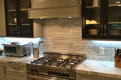 Mid-sized trendy l-shaped porcelain tile open concept kitchen photo in Los Angeles with shaker cabinets, gray cabinets, quartzite countertops, gray backsplash, stone tile backsplash, stainless steel appliances, an island and an undermount sink