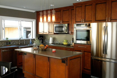 Inspiration for a l-shaped eat-in kitchen remodel in Los Angeles with recessed-panel cabinets, light wood cabinets, brown backsplash, stainless steel appliances and an island