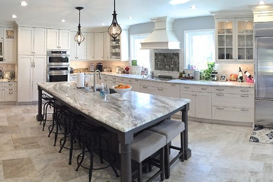 Example of a large transitional l-shaped porcelain tile open concept kitchen design in Baltimore with a farmhouse sink, shaker cabinets, white cabinets, granite countertops, white backsplash, subway tile backsplash, stainless steel appliances and an island