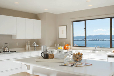 Example of a kitchen design in San Francisco with flat-panel cabinets, white cabinets and an island
