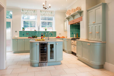 Design ideas for a rural kitchen in Devon with recessed-panel cabinets, blue cabinets, blue splashback, ceramic splashback, white appliances and an island.