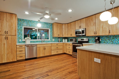 Example of a large 1960s u-shaped bamboo floor kitchen design in Dallas with an undermount sink, flat-panel cabinets, light wood cabinets, quartz countertops, multicolored backsplash, mosaic tile backsplash, stainless steel appliances and a peninsula