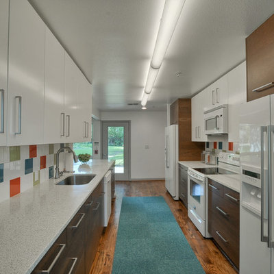 Inspiration for a mid-sized 1960s galley medium tone wood floor eat-in kitchen remodel in Dallas with flat-panel cabinets, multicolored backsplash, white appliances, medium tone wood cabinets, quartz countertops, ceramic backsplash, a peninsula and an undermount sink