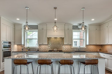 Large trendy u-shaped eat-in kitchen photo in Minneapolis with flat-panel cabinets, white cabinets and an island