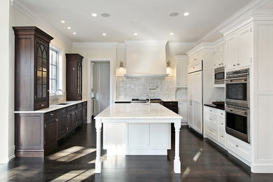 Large transitional u-shaped dark wood floor and brown floor eat-in kitchen photo in Atlanta with an undermount sink, beaded inset cabinets, white cabinets, marble countertops, stainless steel appliances, an island, gray backsplash, marble backsplash and white countertops