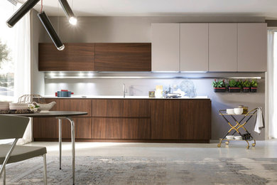 Design ideas for a medium sized contemporary single-wall kitchen/diner in Denver with a submerged sink, flat-panel cabinets, dark wood cabinets, integrated appliances, concrete flooring and no island.