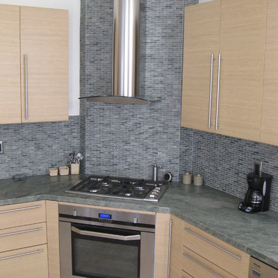 Eat-in kitchen - mid-sized contemporary l-shaped ceramic tile eat-in kitchen idea in San Diego with a single-bowl sink, flat-panel cabinets, light wood cabinets, granite countertops, multicolored backsplash, mosaic tile backsplash, paneled appliances and no island
