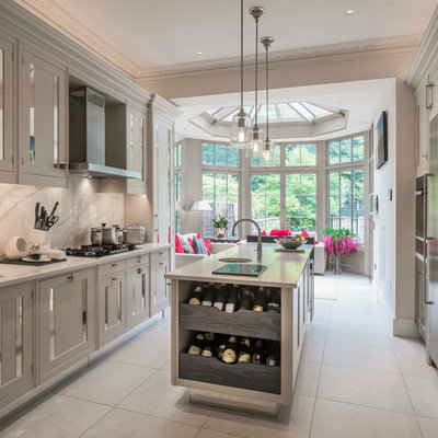 Mid-sized transitional galley gray floor eat-in kitchen photo in London with an undermount sink, recessed-panel cabinets, gray cabinets, white backsplash, marble backsplash and an island