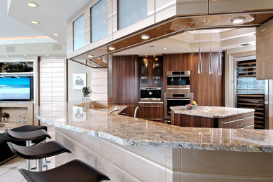 Photo of a contemporary u-shaped enclosed kitchen in Miami with flat-panel cabinets, medium wood cabinets, granite worktops, stainless steel appliances, an island and beige floors.