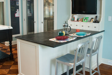 Eat-in kitchen - mid-sized transitional l-shaped light wood floor eat-in kitchen idea in New York with an undermount sink, white cabinets, granite countertops, stainless steel appliances and an island